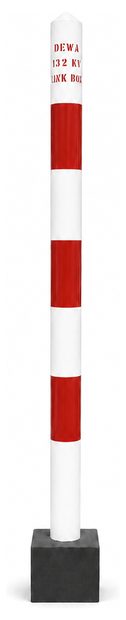 Tall red and white banded DEWA 132 kV route marker
